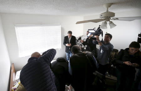 Members of the media are seen inside the home of suspects Syed Rizwan Farook and Tashfeen Malik in Redlands, California December 4, 2015, following Wednesday's attacks in San Bernardino. REUTERS/Mario Anzuoni