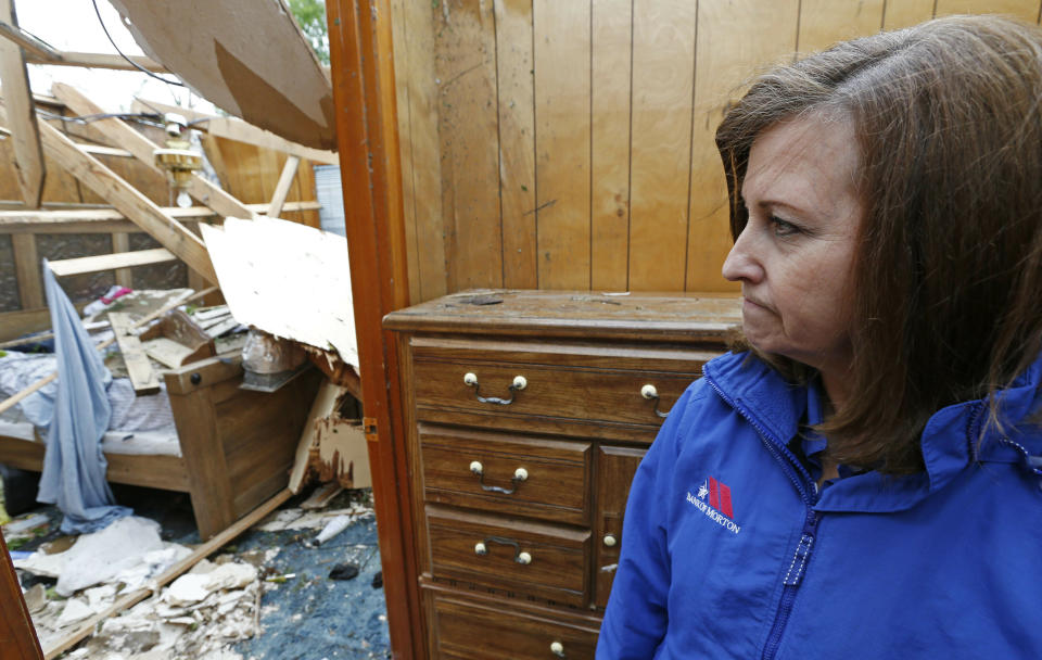 Janet Shoemaker gasps as she looks into the bedroom of what had been a family member's home, Friday, April 19, 2019 in Morton, Miss. The house was recently sold and its occupant had moved in. Strong storms again roared across the South on Thursday, topping trees and leaving a variety of damage in Mississippi, Louisiana and Texas. (AP Photo/Rogelio V. Solis)