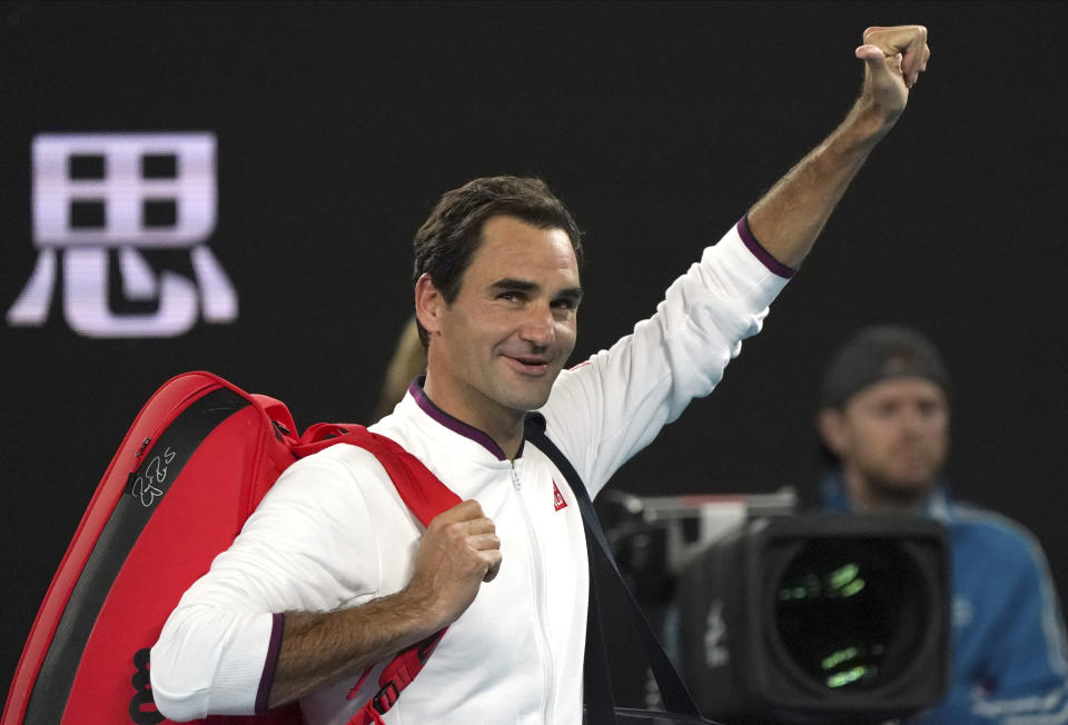 Switzerland's Roger Federer gestures to the crowd as he leaves Rod Laver Arena after defeating Hungary's Marton Fucsovics in their fourth round singles match at the Australian Open tennis championship in Melbourne, Australia, Sunday, Jan. 26, 2020. (AP Photo/Lee Jin-man)