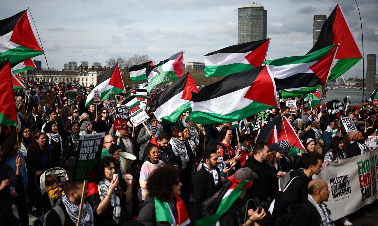 <span>Pro-Palestinian activists marching to the US embassy in London on Saturday.</span><span>Photograph: Henry Nicholls/AFP/Getty Images</span>