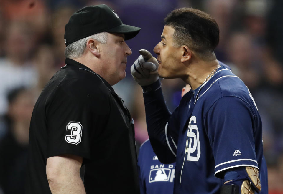 San Diego Padres shortstop Manny Machado, right, yells at home plate umpire Bill Welke, who had called Machado out on strikes during the fifth inning of the team's baseball game against the Colorado Rockies on Saturday, June 15, 2019, in Denver. (AP Photo/David Zalubowski)