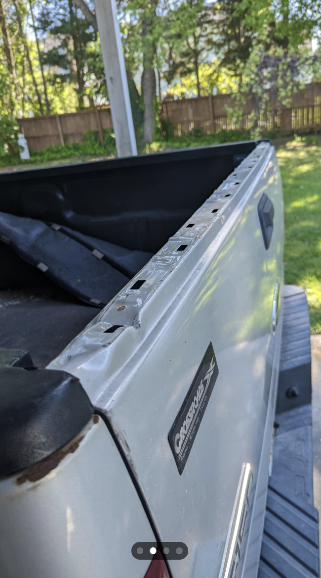 Close-up of a damaged car rooftop cargo box with the "CARGOLOCS" brand visible