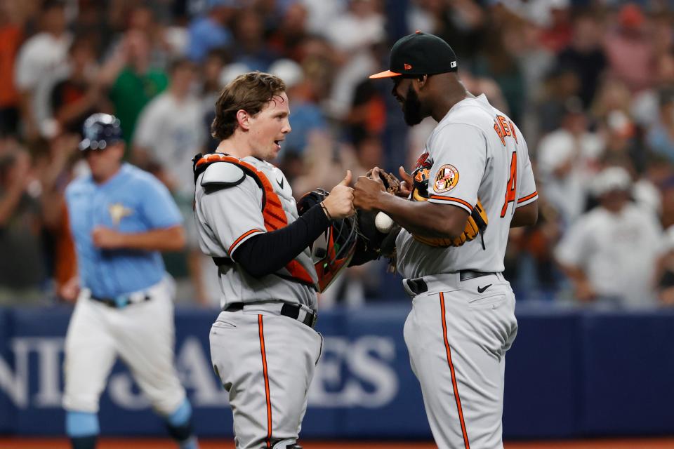 Adley Rutschman and Felix Bautista celebrate after the Orioles'  win at Tropicana Field on Sunday.