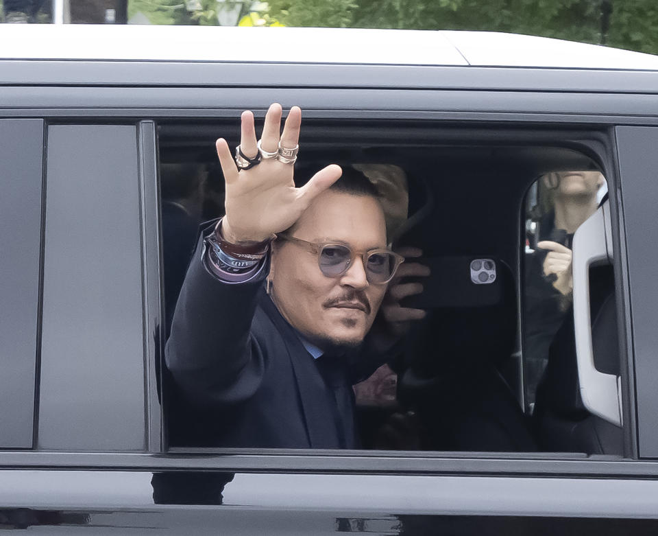Johnny Depp waves to his fans as he arrives outside court during the Johnny Depp and Amber Heard civil trial at Fairfax County Circuit Court on May 27, 2022 in Fairfax, Virginia. Depp is seeking $50 million in alleged damages to his career over an op-ed Heard wrote in the Washington Post in 2018.(Photo by Ron Sachs/Consolidated News Pictures/Getty Images)