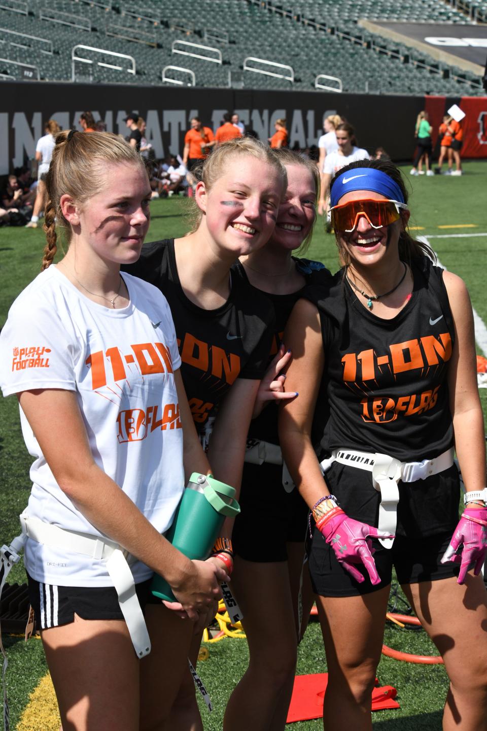 From left, Notre Dame Academy's Isabelle Fettig, Maddie Janszen, Sophia Graham and Annie Dierker are ready to play football at the girls flag football kickoff jamboree sponsored by USA Football and the Cincinnati Bengals at Paycor Stadium, Sept. 30, 2023.