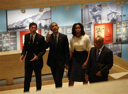 U.S. President Barack Obama (2nd L) and first lady Michelle Obama tour the LBJ Presidential Library before speaking at a Civil Rights Summit to commemorate the 50th anniversary of the signing of the Civil Rights Act in Austin, Texas April 10, 2014. REUTERS/Kevin Lamarque