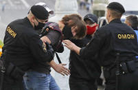 Police officers detain a protester during a protest rally against the removal of opposition candidates from the presidential elections in Minsk, Belarus, Tuesday July 14, 2020. Election authorities in Belarus on Tuesday barred two main rivals of authoritarian leader Alexander Lukashenko from running in this summer's presidential election. (AP Photo/Sergei Grits)