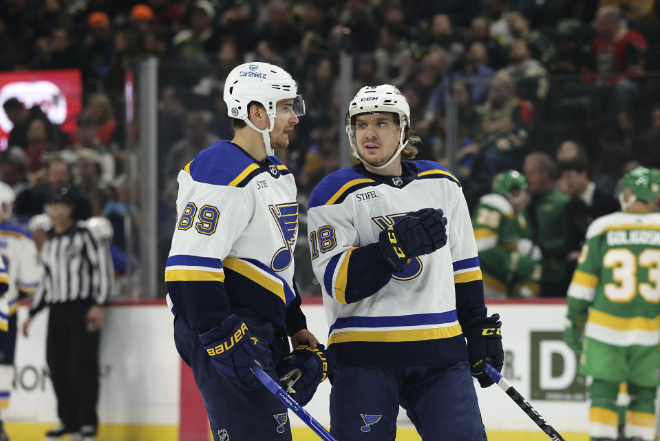 St. Louis Blues left wing Pavel Buchnevich (89) talks to center Robert Thomas (18) during the first period of an NHL hockey game against the Minnesota Wild, Sunday, Jan. 8, 2023, in St. Paul, Minn. (AP Photo/Stacy Bengs)
