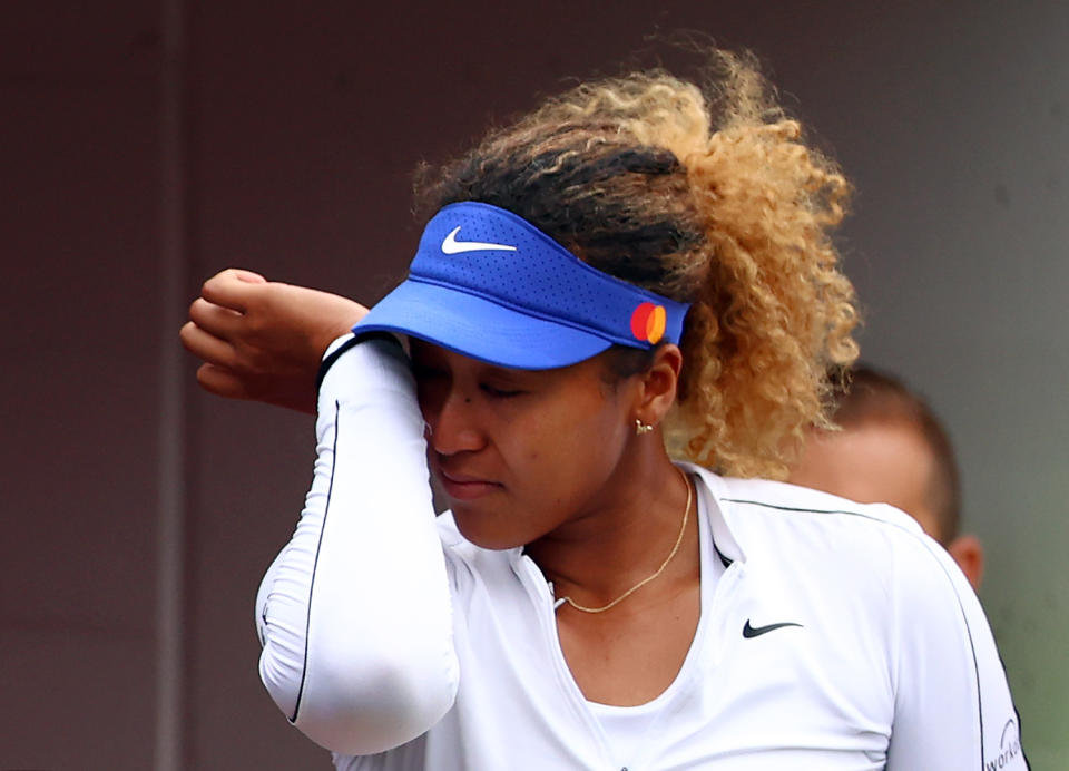 Naomi Osaka, pictured here wiping away tears after retiring hurt at the Canadian Open.