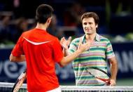 France's Fabrice Santoro (R) shake hands with Serbia's Novak Djokovic after their match in the Paris Bercy Tennis Open October 31, 2007. Santorot won the match. REUTERS/Charles Platiau (FRANCE) - RTR1VIL7