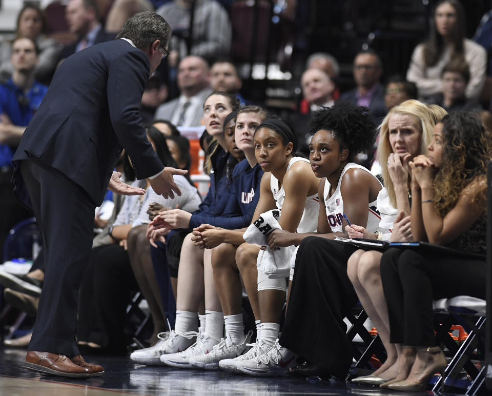 Connecticut head coach Geno Auriemma, left, talks with Connecticut's Christyn Williams, third from right, during the first half of an NCAA college basketball game in the American Athletic Conference tournament quarterfinals, Saturday, March 9, 2019, at Mohegan Sun Arena in Uncasville, Conn. (AP Photo/Jessica Hill)