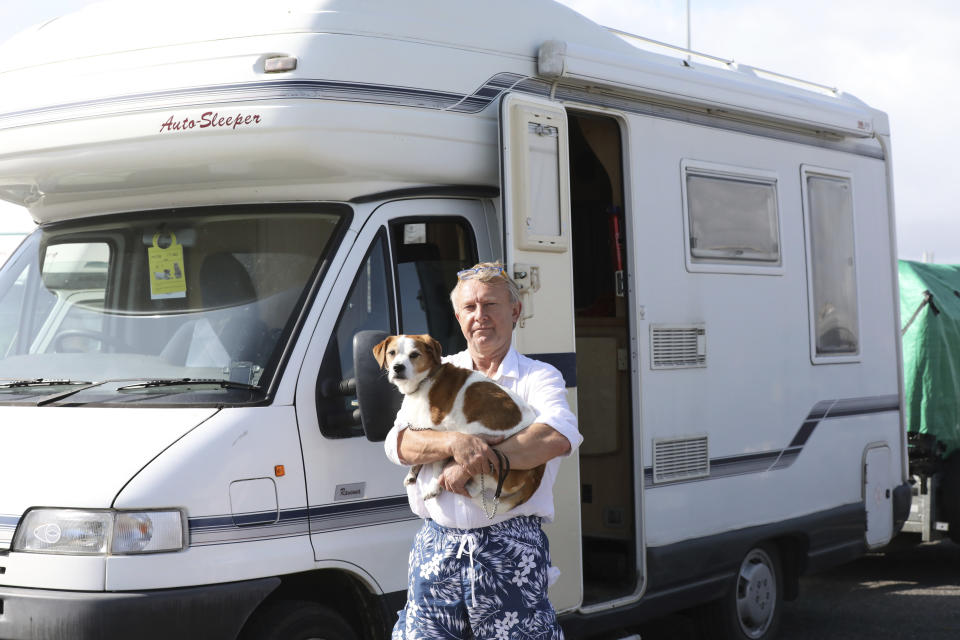 Mark Elsden waiting to board the ferry to Dieppe in northern France with his dog Alfie at Newhaven harbour, southern England, Monday, Aug. 19, 2019. Across Europe, pet owners like Katherine are seamlessly crossing borders with their beloved dog, cat or even ferret, thanks to the EU Pet Passport scheme, but now, as a no-deal Brexit looms for Britain, free pet travel is under threat. (AP Photo/Natasha Livingstone)