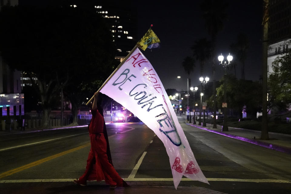 A woman carries a sign that reads, "all votes must be counted," Wednesday, Nov. 4, 2020, in Los Angeles, after the Nov. 3 elections. (AP Photo/Jae C. Hong)