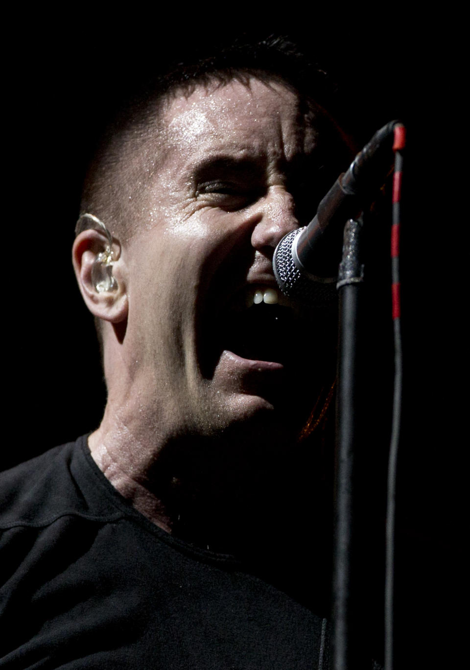 In this March 27, 2014 photo, Trent Reznor of Nine Inch Nails performs at the Vive Latino music festival in Mexico City, Mexico. At first Reznor was hesitant about embarking on tour. “Life feels different at 48 than it did at 24. I don’t know how much longer I’ll be doing this, or people will care ... it’s not as endless as it once seemed, so I treat it more preciously.” (AP Photo/Rebecca Blackwell)