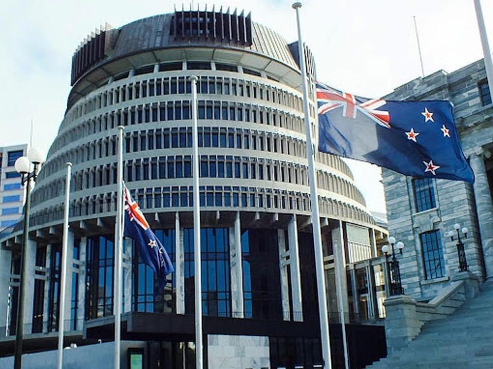 An outside view of New Zealand's parliament building with flags