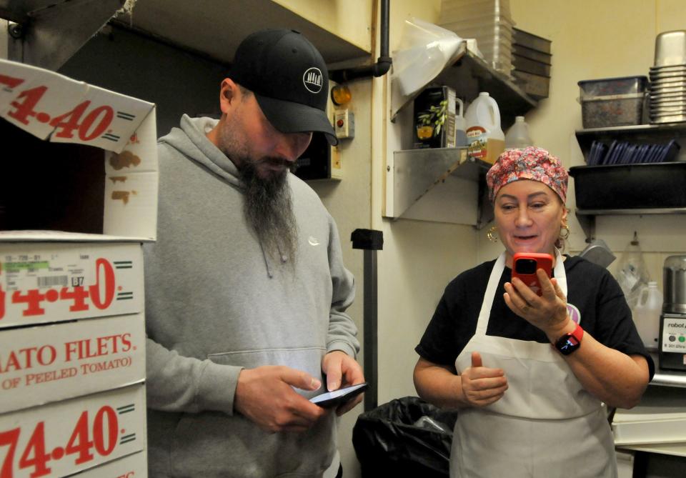 With Siena executive chef Nick Jankowski, Vittoria Tassoni, right, speaks into her phone that is used to help translate conversations from Italian to English and English into Italian. Tassoni is an Italian blogger and cook who is working with chefs at Siena in Mashpee Commons. To see more photos, go to www.capecodtimes.com.