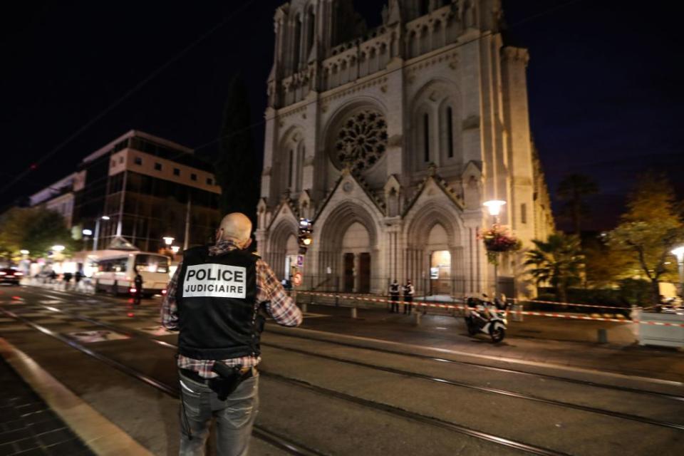 A police investigator stands by the Notre-Dame de l'Assomption Basilica in Nice.