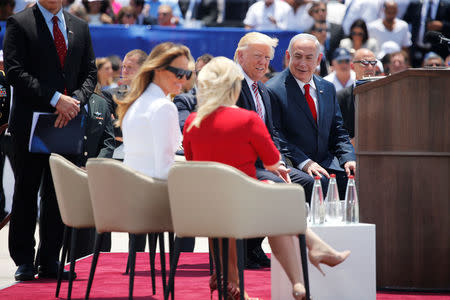 U.S. First Lady Melania Trump (seated, L) chats wife Sara Netanyahu (seated, front) as U.S. President Donald Trump (C) chats to Israel's Prime Minister Benjamin Netanyahu (R) during a welcoming ceremony to welcome Trump at Ben Gurion International Airport in Lod near Tel Aviv, Israel May 22, 2017. REUTERS/Jonathan Ernst