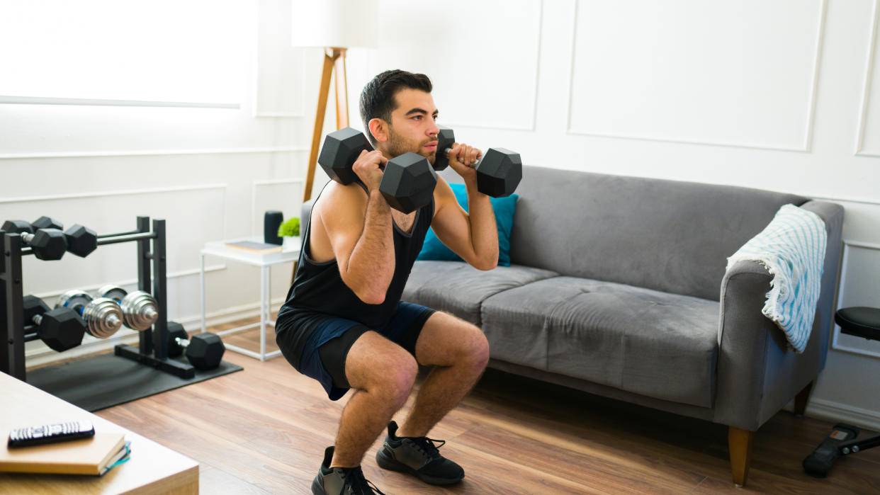  Man performing weighted squats 