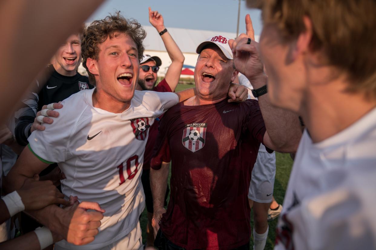MBA’s Hogan Walker (10) celebrates his head coach Giles Cheevers after defeating CPA in a Division II AA state championship game at the Richard Siegel Soccer Complex in Murfreesboro, Tenn., Thursday, May 25, 2023.