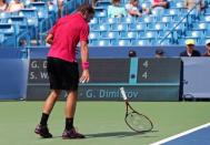 Aug 18, 2016; Mason, OH, USA; Stan Wawrinka (SUI) throws his racquet after returning a shot against Grigor Dimitrov (BUL) on day six during the Western and Southern tennis tournament at Linder Family Tennis Center. Mandatory Credit: Aaron Doster-USA TODAY Sports