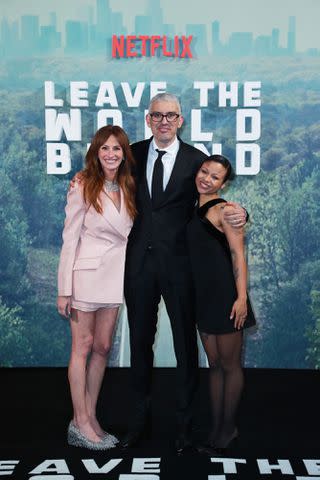 <p>Gareth Cattermole/Getty </p> Julia Roberts with her 'Leave The World Behind' director Sam Esmail and castmate Myha'la Herrold at a London screening of the Netflix film.