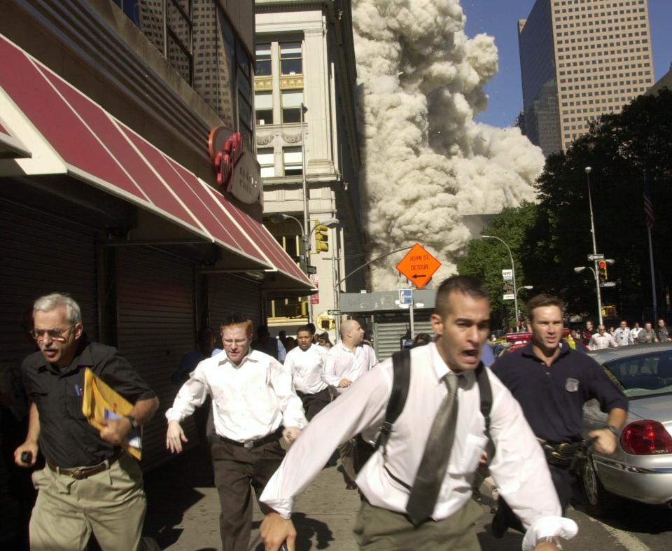 People run from the collapse of one of the twin towers of New York's World Trade Center in this Sept. 11, 2001 file photo.