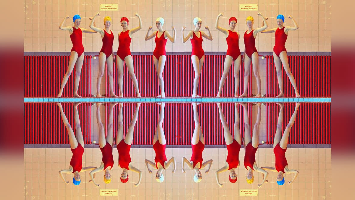  Photograph of female swimming team at a swimming pool, reflected in the water, by hasselblad Heroine Maria Svarbova. 