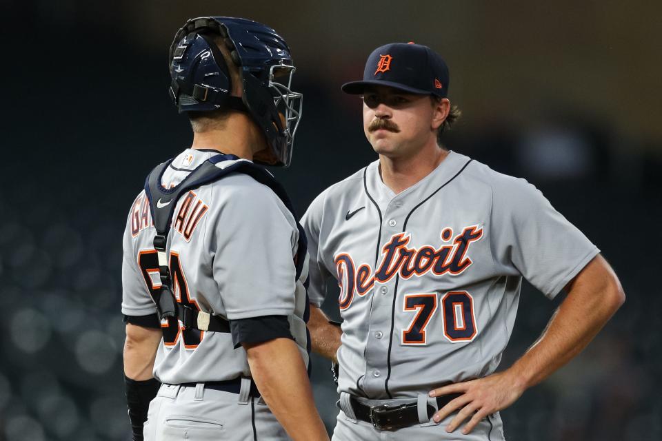 Tigers catcher Dustin Garneau talks to Tigers pitcher Tyler Alexander in the first inning on Tuesday, Sept. 28, 2021, in Minneapolis.