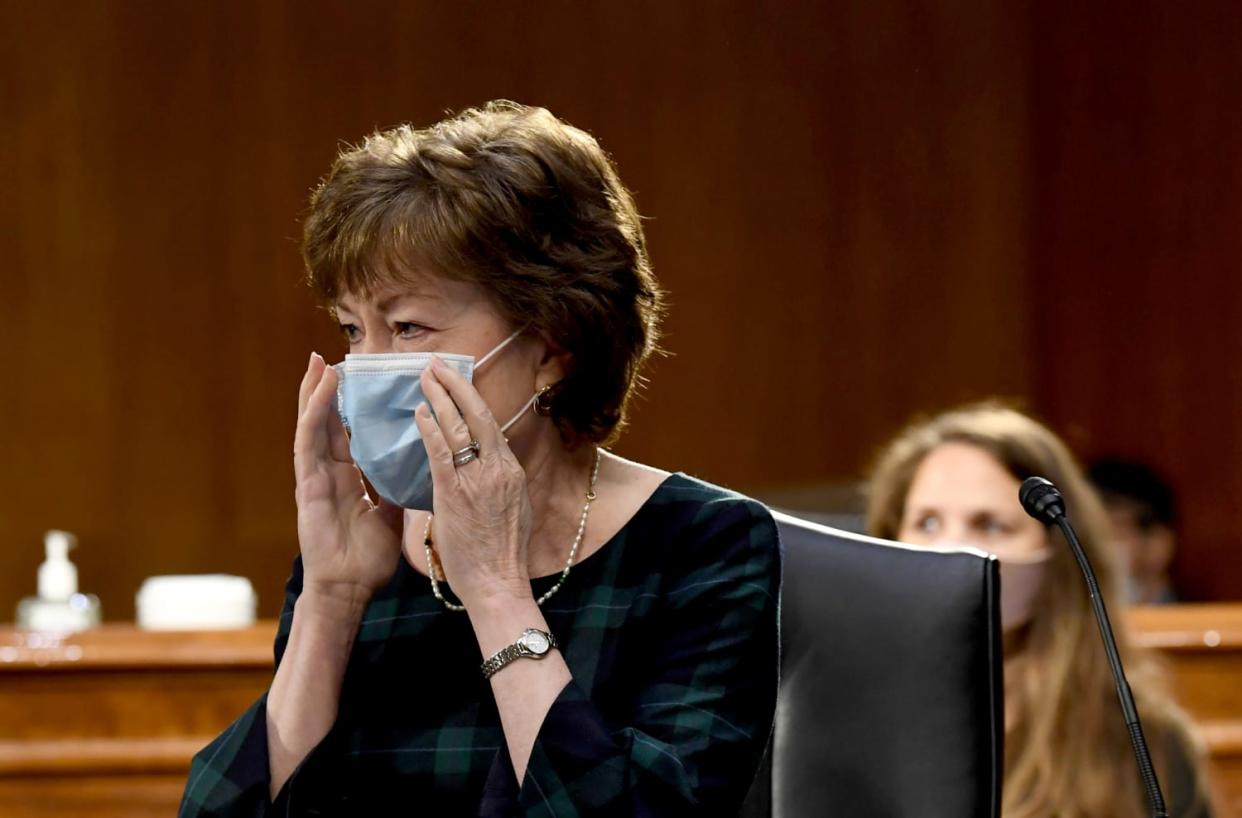 Image: Sen. Suasn Collins, R-ME, adjusts her mask before a committee hearing in Washington on May 12, 2020. (Toni L. Sandys / AFP - Getty Images file)