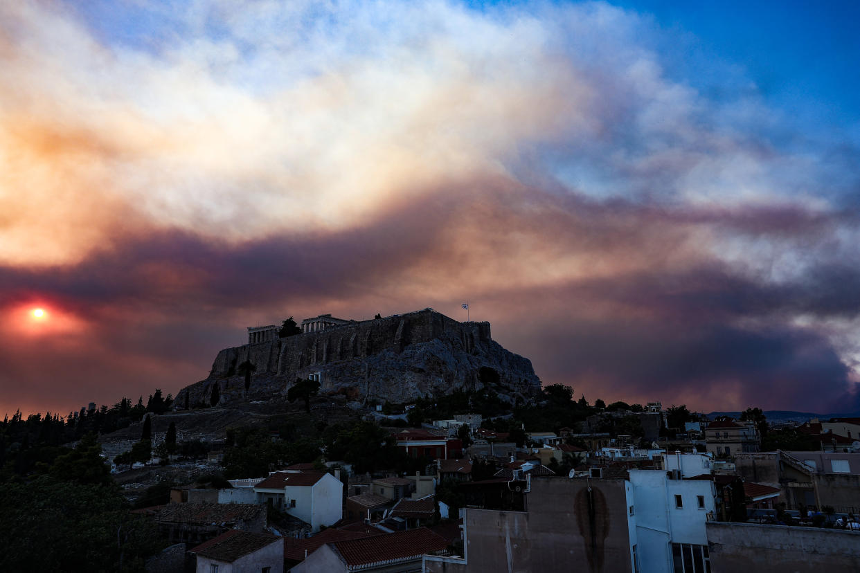 Smoke rises over the Acropolis Hill and the Parthenon from a wildfire that is burning at the western suburbs of the city of Athens, on August 22, 2023 (Photo by Theodore Manolopoulos / SOOC / SOOC via AFP) (Photo by THEODORE MANOLOPOULOS/SOOC/AFP via Getty Images)