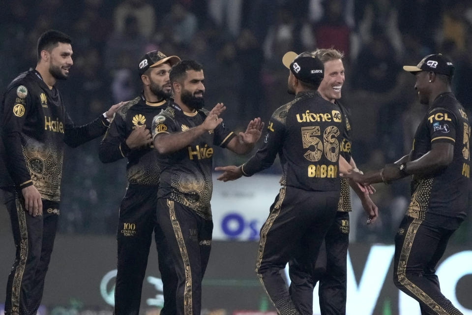 Peshawar Zalmi' Arif Yaqoob, thrid left, celebrates with teammates after taking the wicket during the Pakistan Super League T20 cricket match between Peshawar Zalmi and Islamabad United, in Lahore, Pakistan, Monday, Feb. 26, 2024. (AP Photo/K.M. Chaudary)