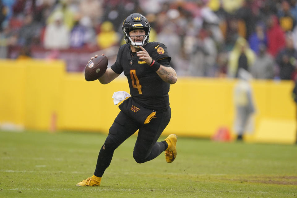 Washington Commanders quarterback Taylor Heinicke (4) scrambles out of the pocket as he looks for an open reciever during the second half of an NFL football game against the Atlanta Falcons, Sunday, Nov. 27, 2022, in Landover, Md. (AP Photo/Patrick Semansky)