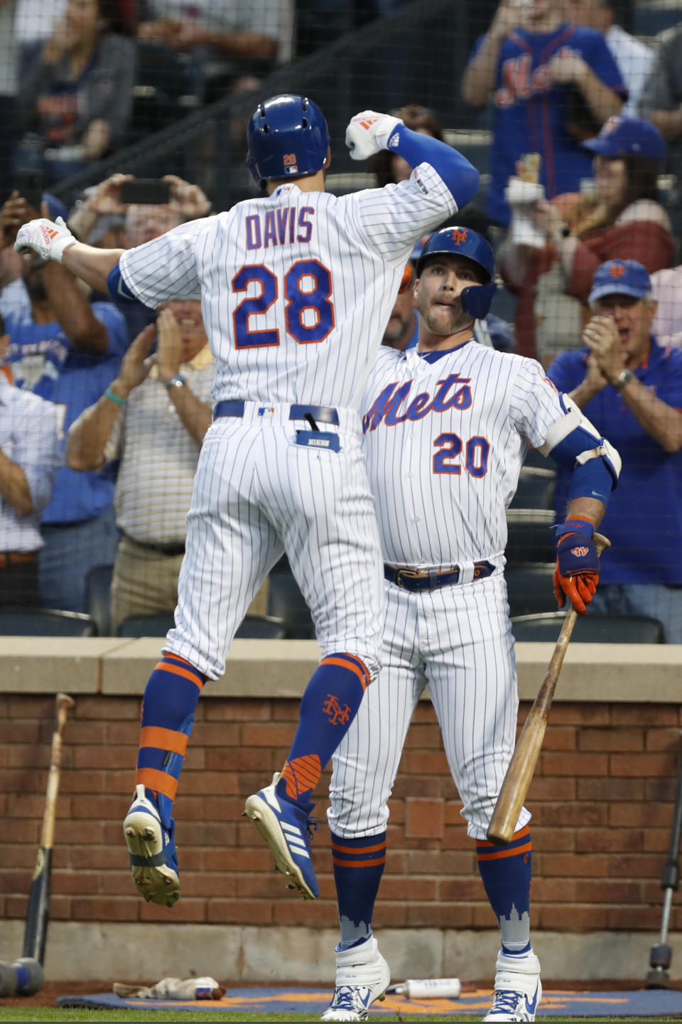 New York Mets on-deck batter Pete Alonso (20) celebrates with teammate J.D. Davis (28) after Davis hit a solo home run off Chicago Cubs starting pitcher Jon Lester during the first inning of a baseball game Thursday, Aug. 29, 2019, in New York. (AP Photo/Kathy Willens)