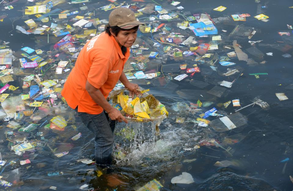 Plastic bags and garbage are collected from the waters of Manila Bay in July 2014 during a campaign by environmental activists and volunteers calling for a ban of the use of plastic bags. Volunteers from various environmental advocates collected and separated assorted plastic rubbish polluting Manila Bay and called for national legislation against plastic bags.