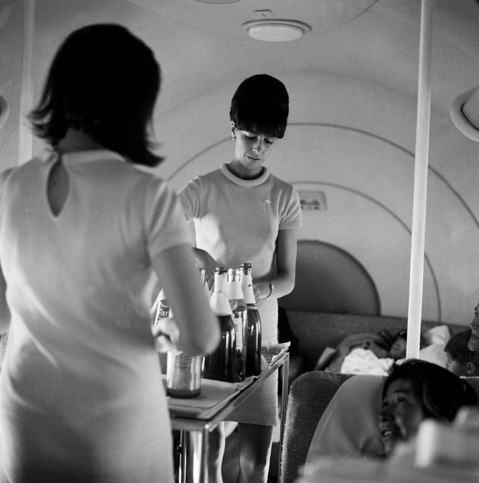 Flight attendants serving beverages on an LAN Airways flight in the 1960s.