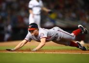 May 11, 2018; Phoenix, AZ, USA; Washington Nationals base runner Andrew Stevenson dives back to first base on a fourth inning pickoff attempt against the Arizona Diamondbacks at Chase Field. Mandatory Credit: Mark J. Rebilas-USA TODAY Sports