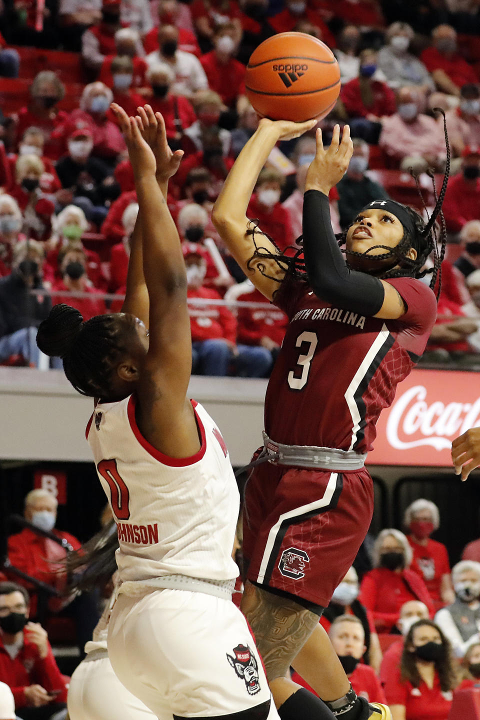 South Carolina's Destanni Henderson (3) shoots over North Carolina State's Diamond Johnson (0) during the first half of an NCAA college basketball game, Tuesday, Nov. 9, 2021 in Raleigh, N.C. (AP Photo/Karl B. DeBlaker)