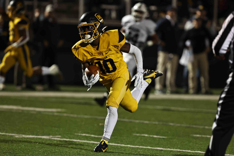 Moeller wide receiver Tennell Bryant scores a touchdown during a playoff game between Mason and Moeller high schools Friday, Nov. 11.