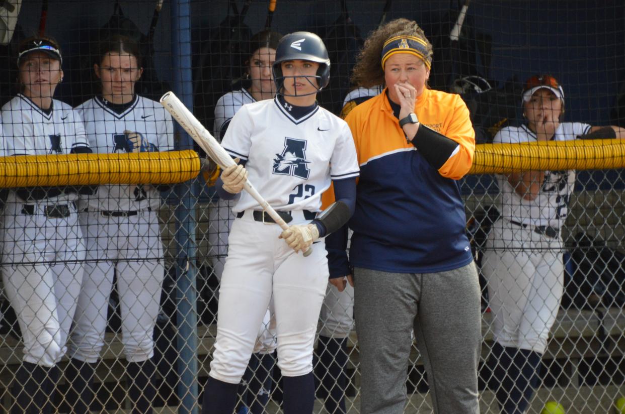 Airport softball coach Jess Irwin gives instructions to Peyton Zajac during a 7-0 win over Grosse Ile on Friday, April 19, 2024.