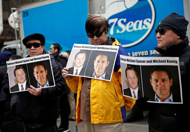 FILE PHOTO: People hold placards calling for China to release Canadian detainees Michael Spavor and Michael Kovrig outside a court hearing for Huawei Technologies Chief Financial Officer Meng Wanzhou at the B.C. Supreme Court in Vancouver