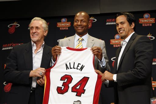 Miami Heat president Pat Riley, left, guard Ray Allen, center, and head coach Erik Spoelstra, right, hold up Allen's jersey after Allen signed an NBA basketball contract with the Heat. (AP)