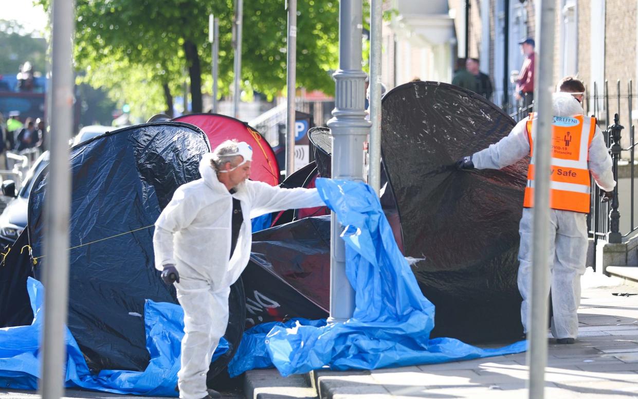 Workers remove tents from Mount Street in Dublin city centre