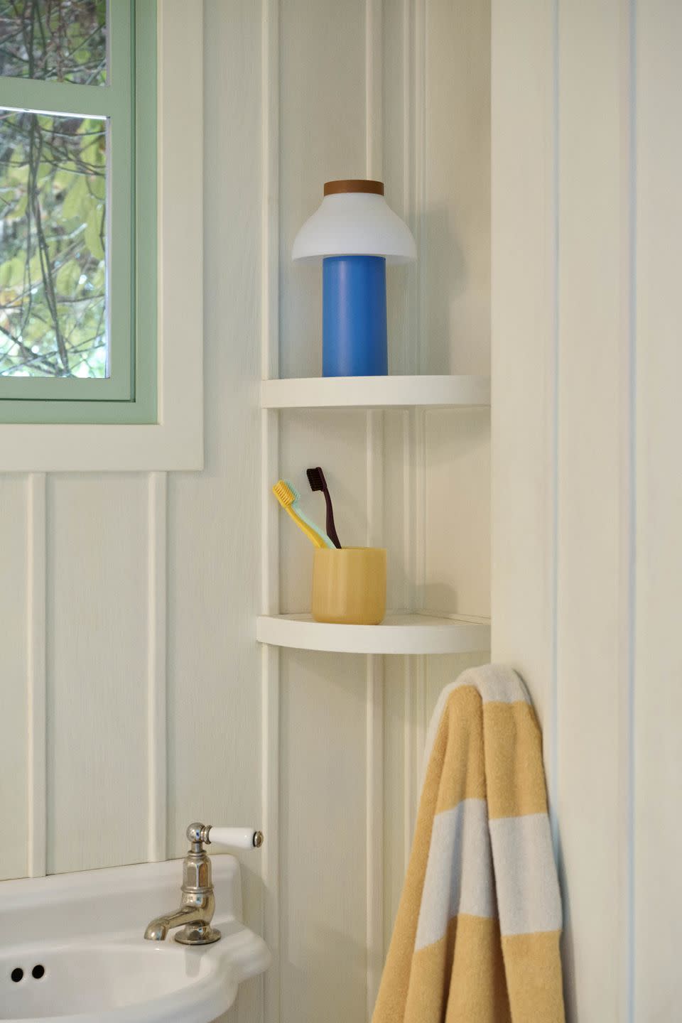 corner shelving in a small neutral bathroom