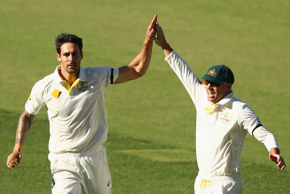 ADELAIDE, AUSTRALIA - DECEMBER 11: Mitchell Johnson and David Warner of Australia celebrate the wicket of Virat Kohli of India during day three of the First Test match between Australia and India at Adelaide Oval on December 11, 2014 in Adelaide, Australia.  (Photo by Robert Cianflone/Getty Images)