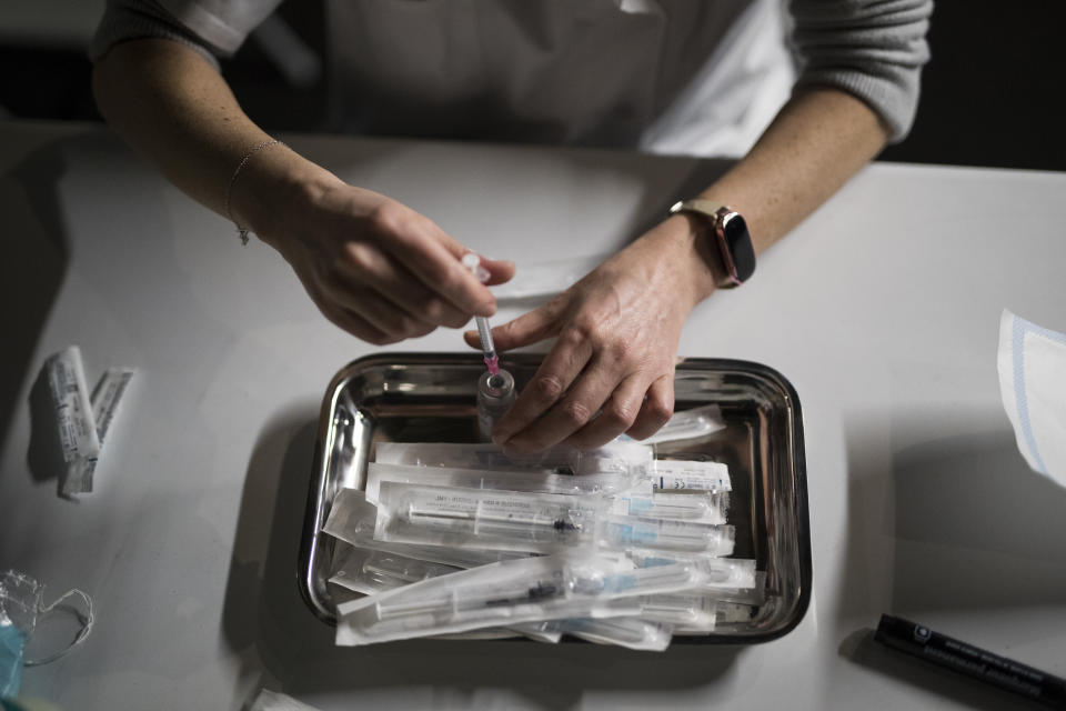 Nurse Coralie Ferron prepares doses of the Moderna COVID-19 vaccine at a vaccination center in Le Cannet, southern France, Thursday Jan. 21, 2021. (AP Photo/Daniel Cole)