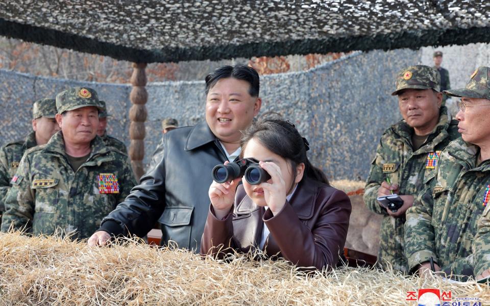 Kim Ju Ae watches paratroop drills with her father and senior military officials