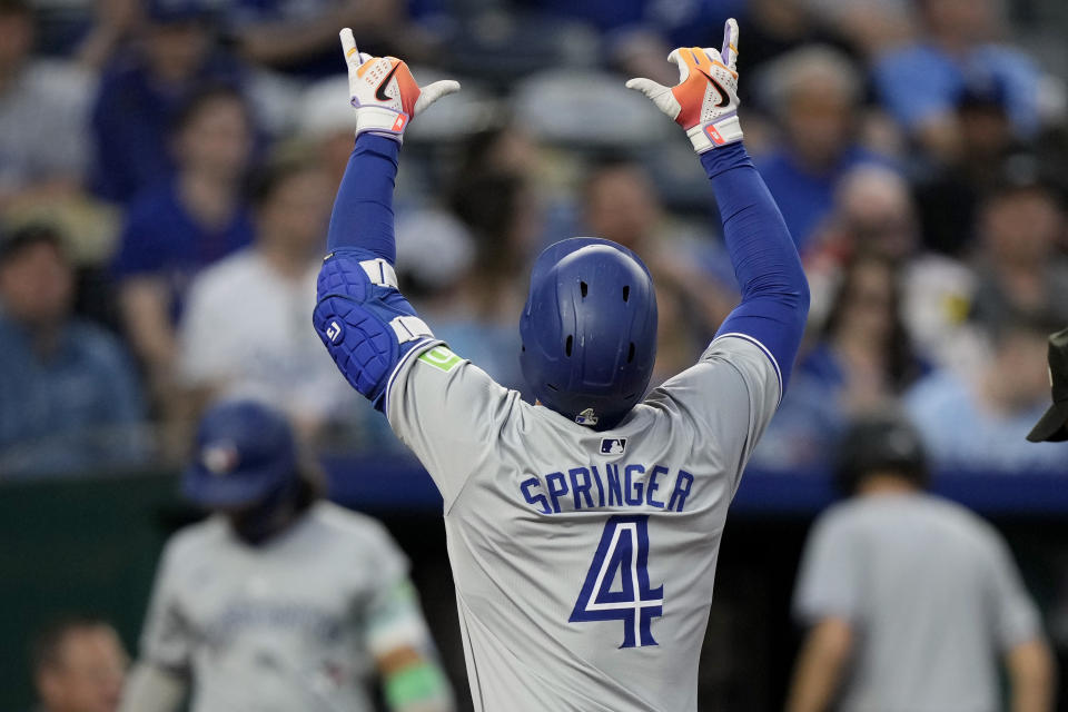 Toronto Blue Jays' George Springer celebrates after hitting a solo home run during the fifth inning of a baseball game against the Kansas City Royals Wednesday, April 24, 2024, in Kansas City, Mo. (AP Photo/Charlie Riedel)