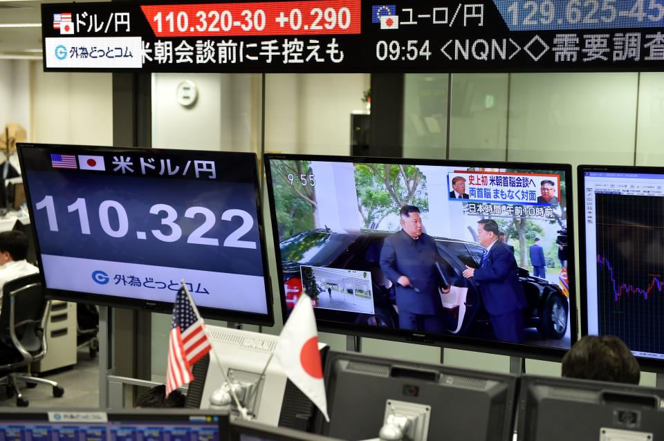 <p>Screens displaying North Korea’s leader Kim Jong Un arriving to meet President Donald Trump in Singapore and the Japanese yen’s exchange rate against the U.S. dollar are seen at a foreign exchange trading company in Tokyo on June 12, 2018. (Photo by Kazuhiro Nogi/AFP/Getty Images) </p>