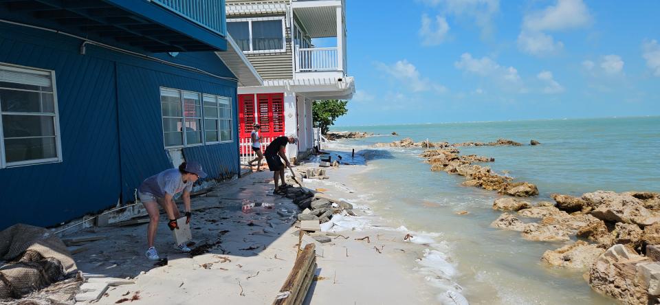 Siobhan Clark and a few helpers built a makeshift barrier to keep the high tide away from her bayside home on Anna Maria Island.